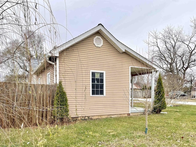 view of side of home with a yard