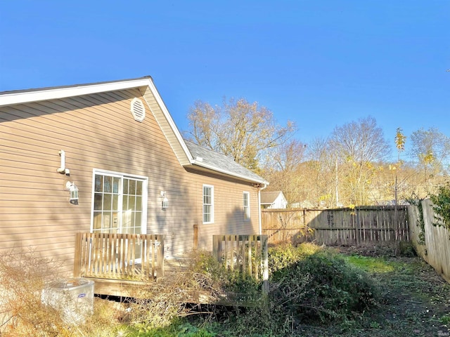 view of side of property with a wooden deck