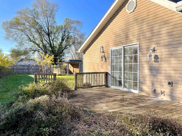 wooden terrace featuring a yard