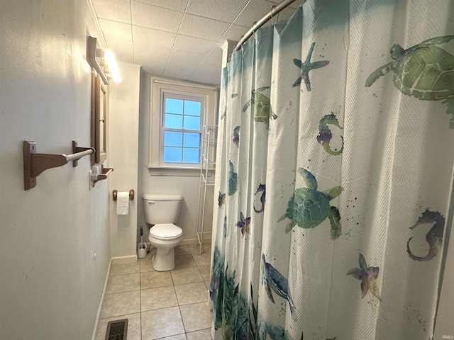 bathroom featuring toilet, tile patterned floors, and walk in shower