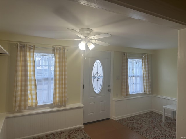 entrance foyer featuring ceiling fan and a wealth of natural light