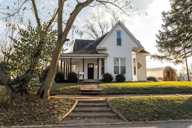 view of front facade with a porch and a front lawn