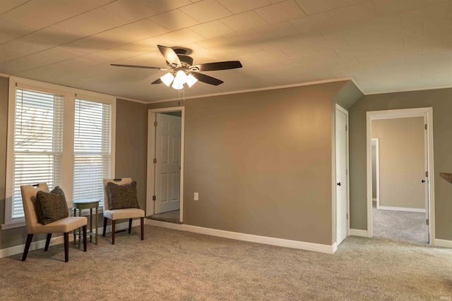 sitting room featuring ceiling fan, carpet, and ornamental molding