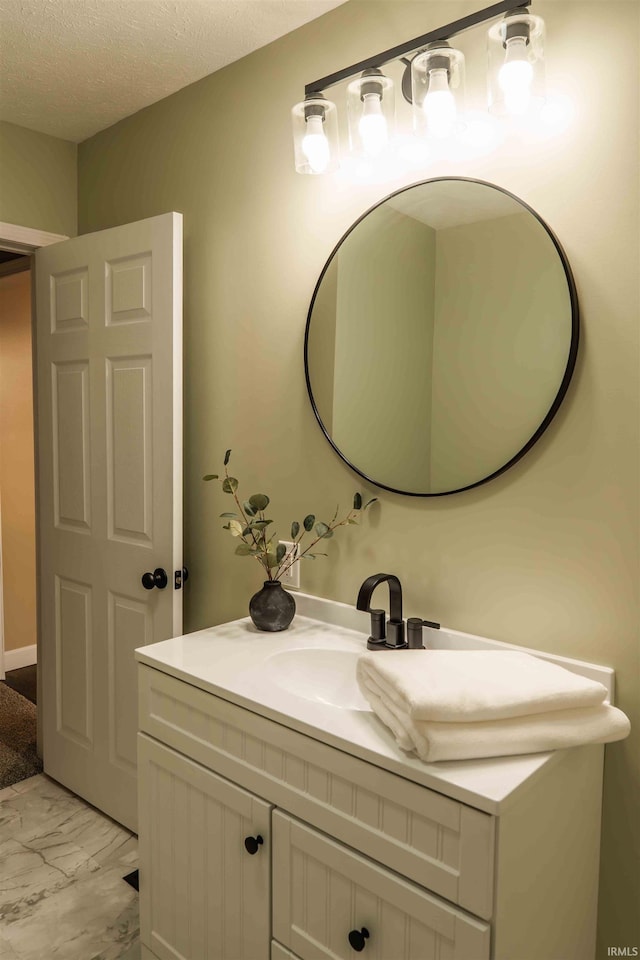 bathroom featuring a textured ceiling and vanity