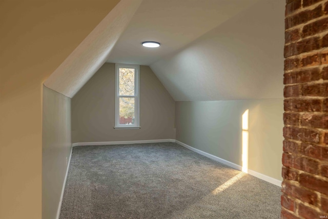 bonus room with lofted ceiling and carpet floors