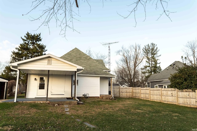 back of property featuring a yard