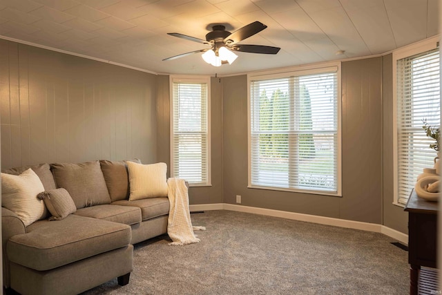 living room with ceiling fan, carpet floors, and ornamental molding