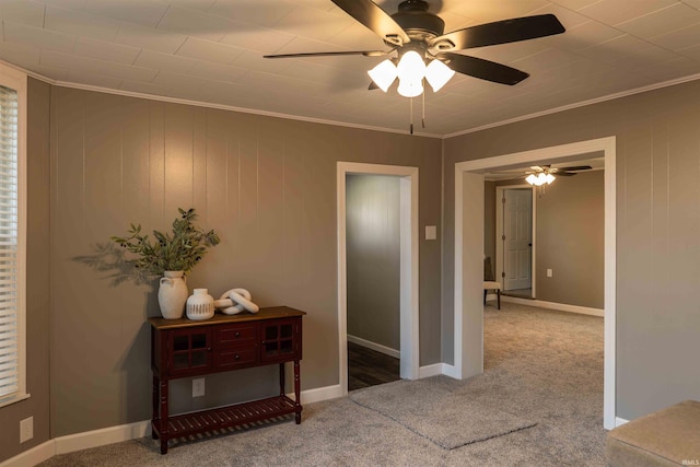 hallway with crown molding, carpet floors, and wood walls