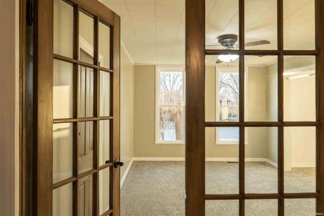 interior space with ceiling fan, french doors, and carpet