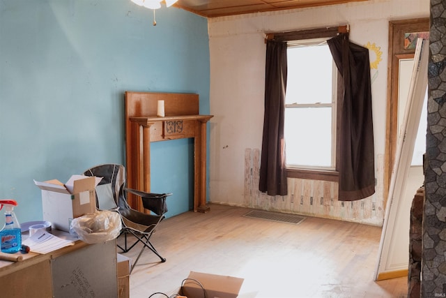 living area with light wood-type flooring and ceiling fan