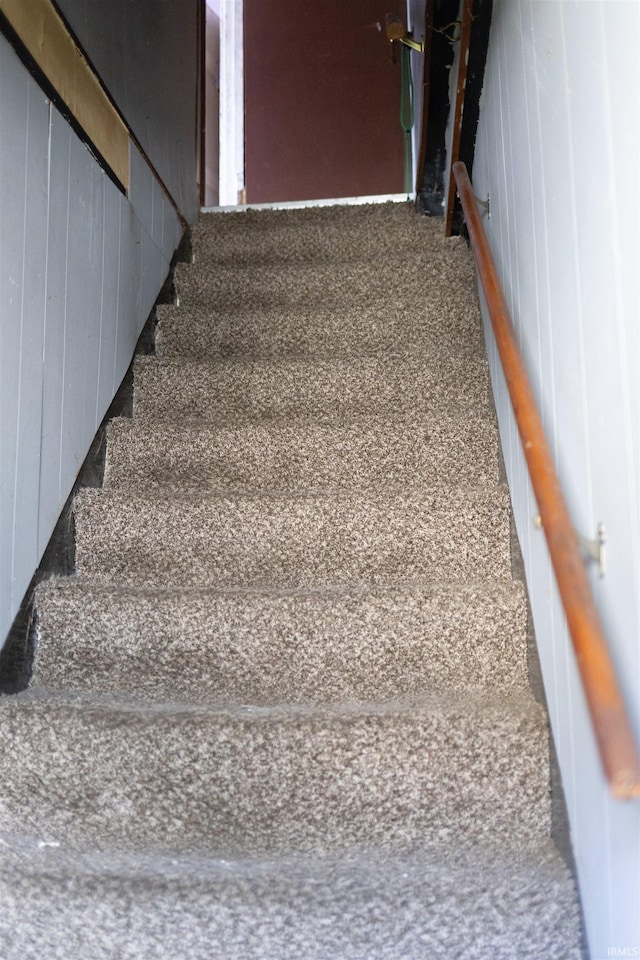 stairs with wood walls