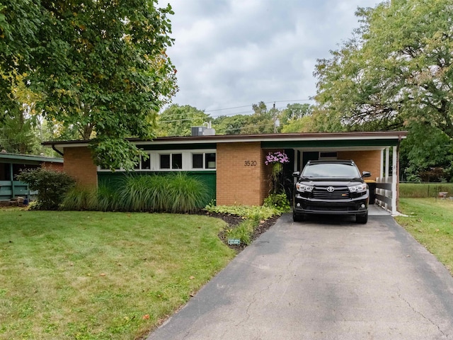 single story home featuring a carport and a front yard