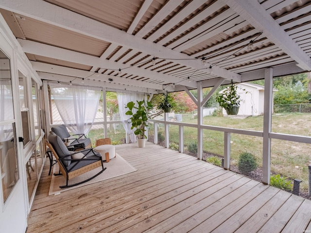 wooden deck featuring a lawn and a storage shed