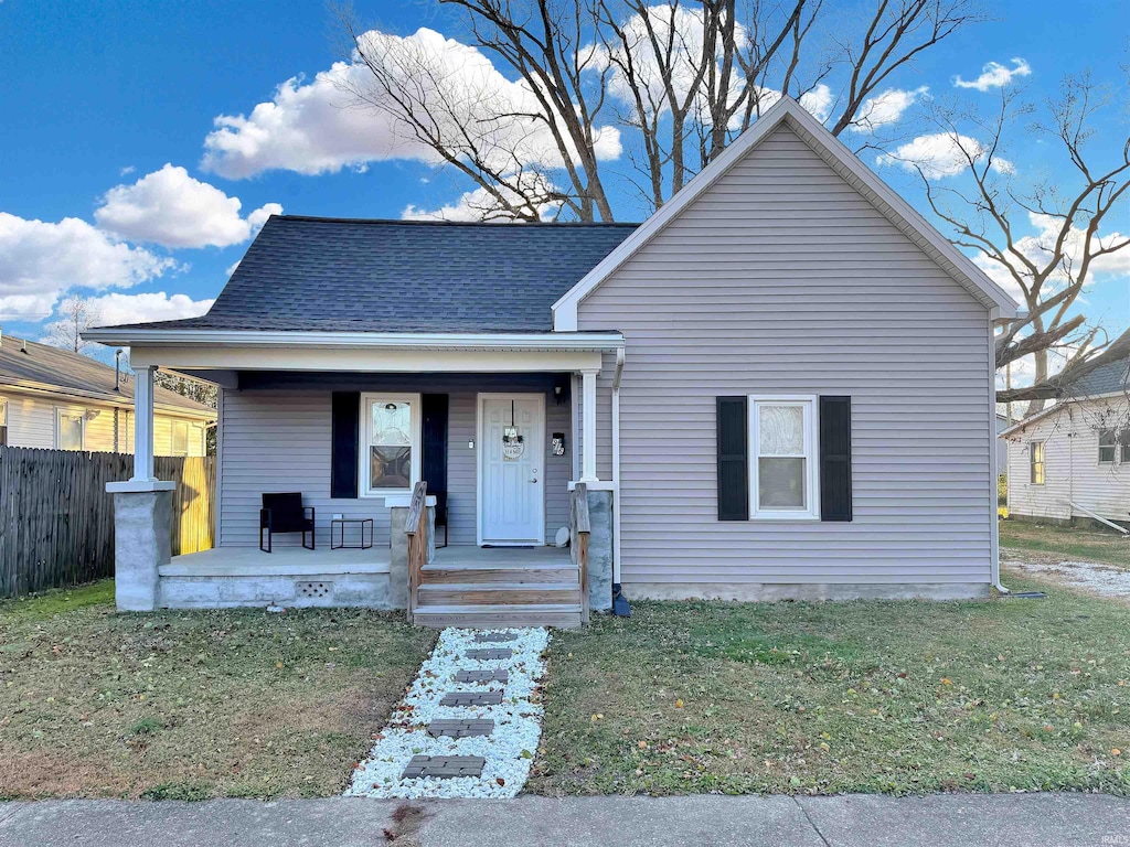 bungalow featuring a porch and a front lawn