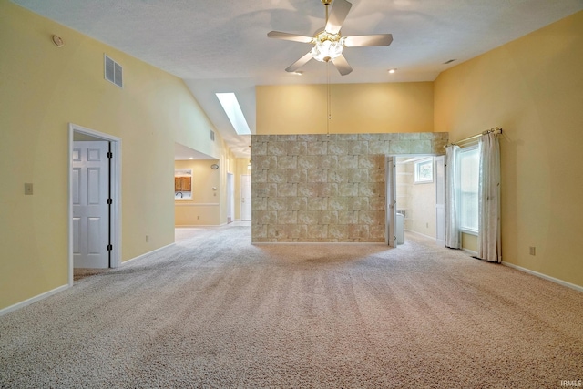 empty room featuring ceiling fan, light carpet, and high vaulted ceiling