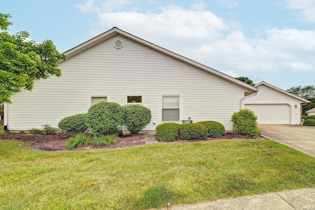 view of property exterior featuring a lawn and a garage