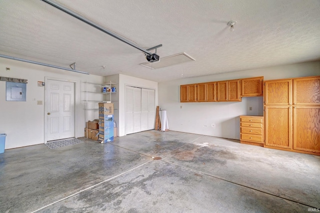 garage featuring electric panel and a garage door opener