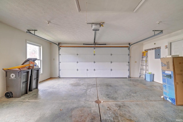 garage featuring electric panel and a garage door opener