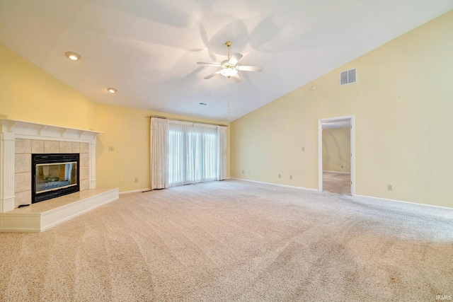 unfurnished living room featuring ceiling fan, a fireplace, carpet floors, and high vaulted ceiling