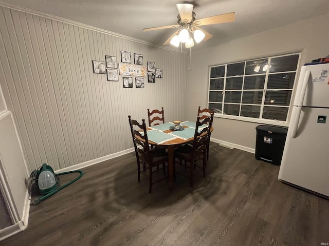 dining space featuring ornamental molding, ceiling fan, and dark wood-type flooring