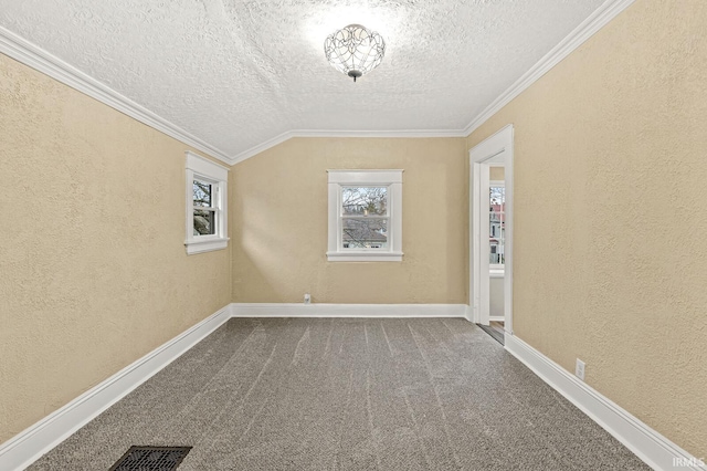 unfurnished room with carpet flooring, ornamental molding, a textured ceiling, and vaulted ceiling