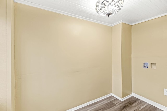 laundry area with hookup for a washing machine, ornamental molding, and hardwood / wood-style flooring