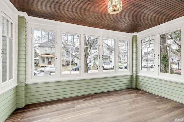 unfurnished sunroom with a healthy amount of sunlight and wood ceiling