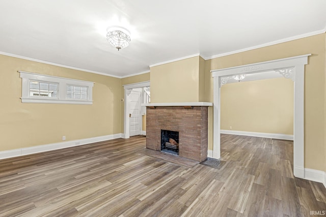 unfurnished living room with a fireplace, wood-type flooring, and crown molding