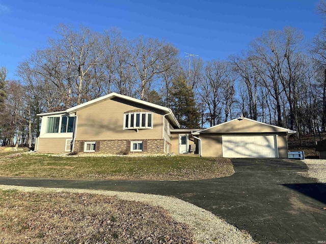 view of side of home featuring a yard and a garage