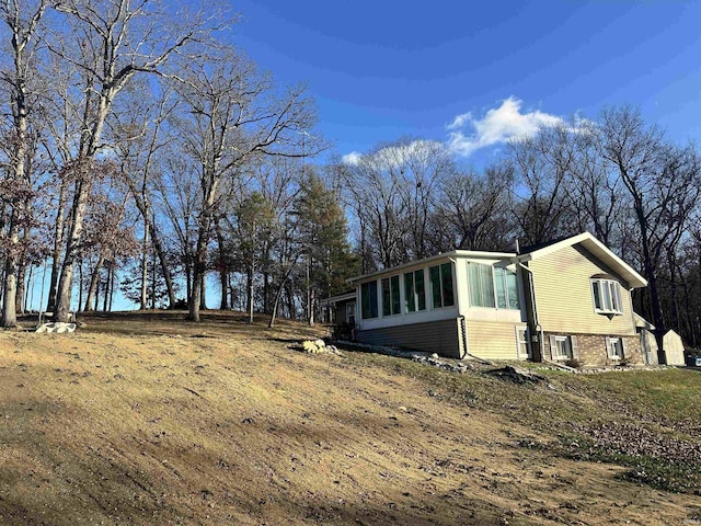 view of property exterior featuring a sunroom