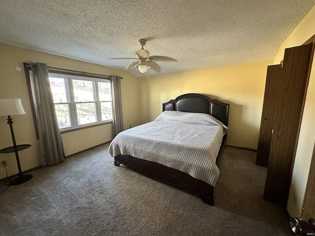 carpeted bedroom with ceiling fan and a textured ceiling