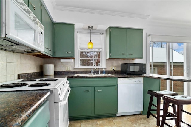 kitchen with white appliances, crown molding, sink, green cabinetry, and tasteful backsplash