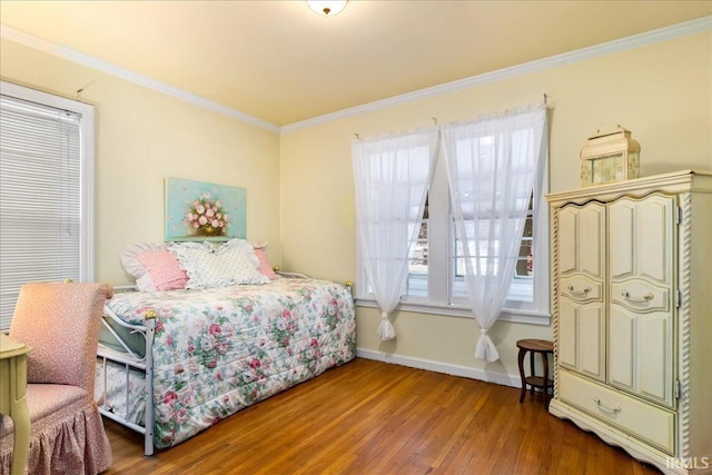 bedroom featuring hardwood / wood-style floors and crown molding