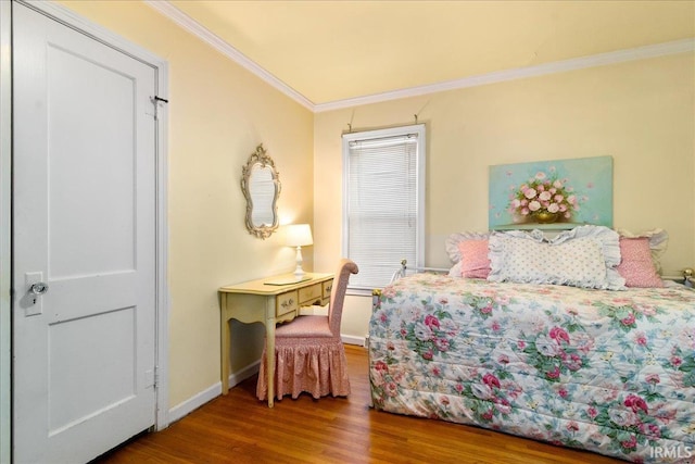 bedroom featuring hardwood / wood-style floors and ornamental molding