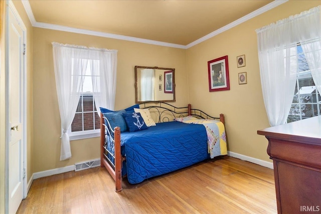 bedroom with wood-type flooring and crown molding