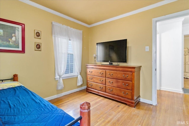 bedroom with light wood-type flooring and crown molding