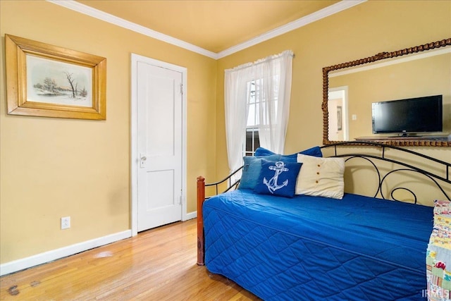 bedroom featuring hardwood / wood-style floors and crown molding