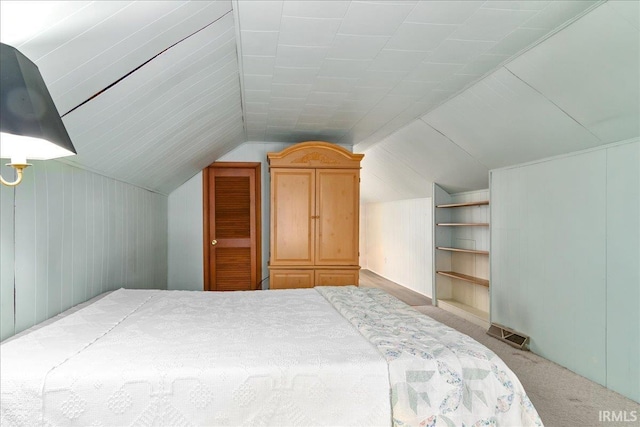 carpeted bedroom featuring vaulted ceiling