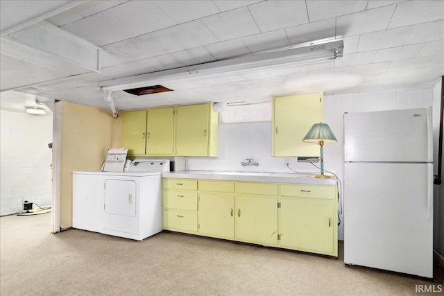 clothes washing area featuring sink, separate washer and dryer, and light carpet