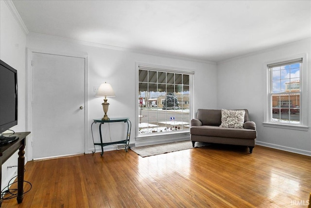 sitting room featuring hardwood / wood-style flooring and crown molding