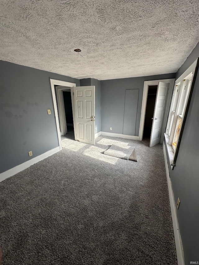 unfurnished bedroom with carpet flooring and a textured ceiling