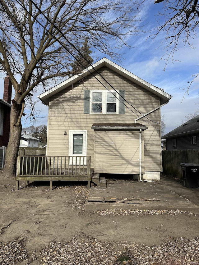 back of house featuring a wooden deck