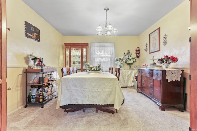 carpeted dining room with a notable chandelier