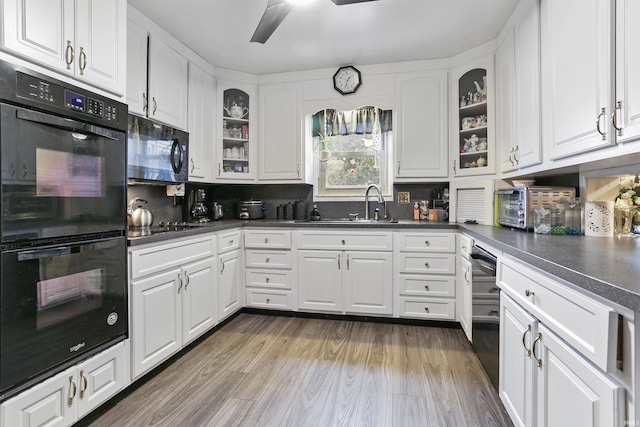 kitchen with hardwood / wood-style floors, black appliances, sink, ceiling fan, and white cabinetry