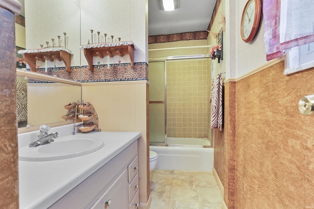 full bathroom featuring tile patterned flooring, vanity, toilet, and bath / shower combo with glass door