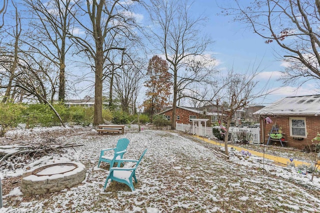 yard covered in snow featuring a fire pit