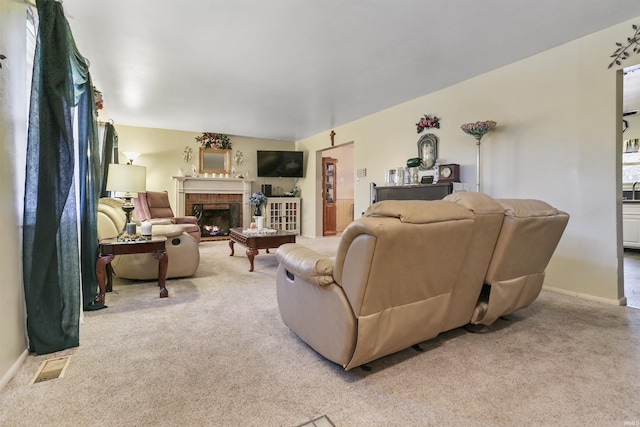 carpeted living room featuring a brick fireplace