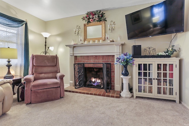 living room with carpet and a brick fireplace