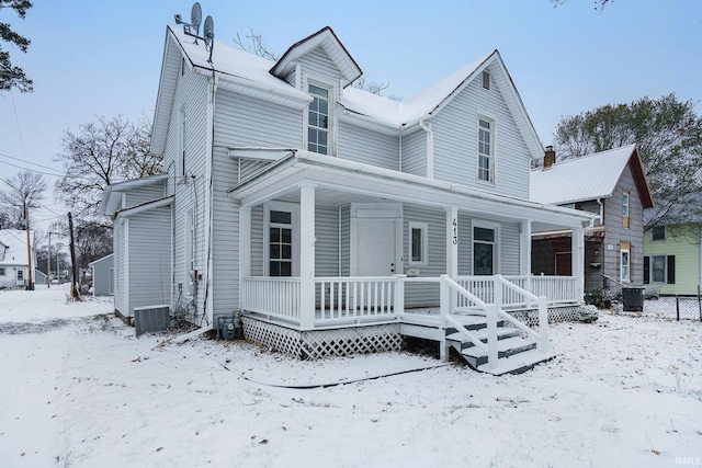 view of front facade with a porch and central AC