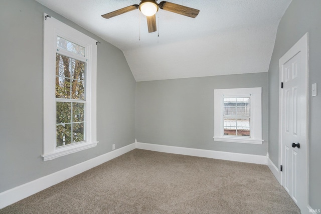 bonus room featuring a textured ceiling, ceiling fan, carpet floors, and lofted ceiling